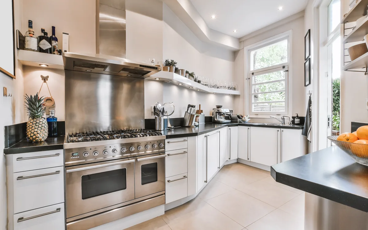 Kitchen with a stainless steel range, scrubbed from top to bottom